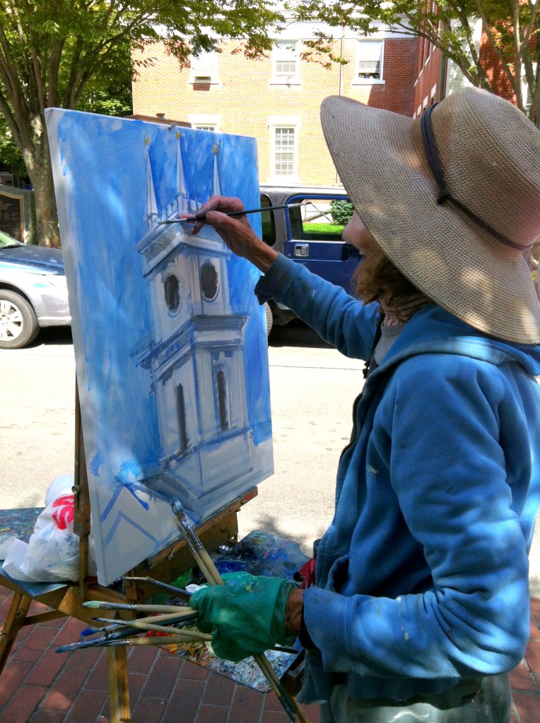 A local artist paints the Edgartown clock tower on the Whaling Church.